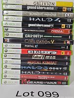 Stack of 16 Xbox 360 game cases showing titles and spine details.