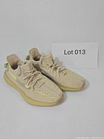 Pair of Yeezy Boost sneakers angled side view showing knit upper and Boost sole.