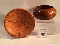 Two hand turned burl bowls side by side, maple burl bowl on left showing fine grain, cedar burl bowl on right with rounded shape and glossy finish