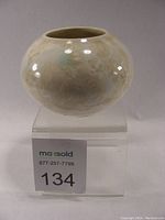 Front view of the rounded crystalline glazed porcelain vase showing surface texture and glaze pattern.