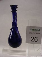 Front view of cobalt blue glass vase with spiral detail and slender shape.