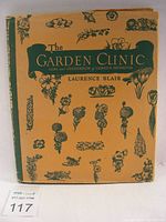 Front cover of The Garden Clinic book with original dust jacket showing green botanical illustrations on tan background.