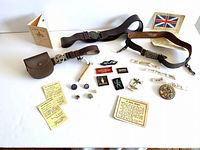 Overview of all items including belts, patches, pins, pencil keychain, and paper test cards.