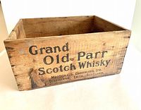 Front view of wooden crate showing Grand Old Parr Scotch Whisky branding with Macdonald Greenlees Ltd Leith Scotland distillers text.