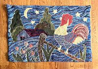 Full view of vintage hooked rug with rooster and starry sky motif on wooden floor, showing overall condition and colors.