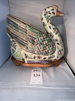 Side view of goose planter on rosewood base showing overall form and enamel decoration