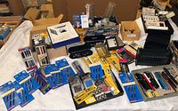 Overview of lot laid out on table showing fountain pens, cartridge packs, nib packs and calligraphy tools.