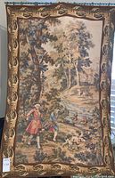 Full front view of tapestry hung on rod showing border and overall design