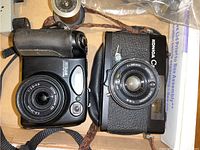 Top view of Nikon CoolPix 5400 and Konica C35 cameras showing lenses and body condition
