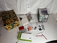 Complete lot laid out showing Nintendo DS console, games stacked, carrying case, screen protectors, styluses, manuals, and storage box