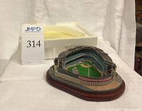 Front angled view of the Old Yankee Stadium model showing the field and stands with stadium packaging foam block.