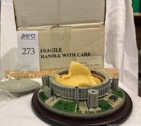 Danbury Mint Astrodome model with dome cover removed showing interior seating and field, wooden base visible.