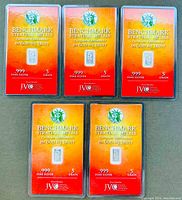 Five sealed 5 grain .999 fine silver bars displayed showing front certificates with branding and purity marks.