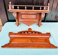 Two pieces shown: floating wall shelf with turned spindles and separate carved wooden decoration.