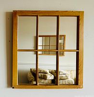 Front angle view of the 6 pane wooden window frame mirror hanging on a wall, showing the rectangular frame and six reflective glass panels.