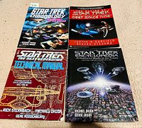 Four softcover Star Trek books arranged in a 2x2 grid on a beige surface.