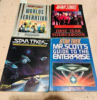 Four softcover Star Trek books laid out showing front covers, various Star Trek themes and artwork.