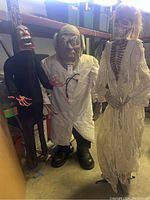 Three figures in storage showing zombie (left), doctor (center), skeleton (right)
