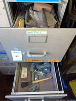 Open drawer labeled 'Hand Tools' showing metal and wood handled hand tools, snips, files, and brushes with minor rust and use marks.