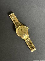 Front and dial view of the vintage RADO gold plated women's watch on black background.