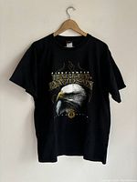 Black t-shirt featuring Harley Davidson Firefighter graphic hung on wooden hanger.