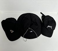 View of all three hats laid side by side showing design and logos