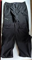 Two pairs of men's pants, one Patagonia and one Lululemon, both black, size medium 34