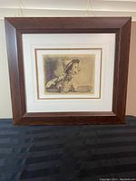 Front view of the framed Disney Pinocchio sketch print sitting on a black surface, showing the overall condition and presentation.