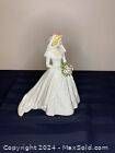 Front view of the Goebel West Germany porcelain wedding bride figurine wearing a flowing wedding dress and holding a bouquet.