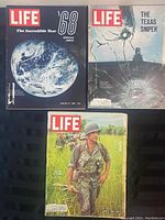 Three Life magazines from the 1960s arranged on a dark surface showing front covers: The Incredible Year '68, The Texas Sniper, and Ugly War in Vietnam.