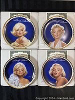 Photo of front faces of 4 collector plates showing portraits of Marilyn Monroe, each plate in original box with visible certificates.