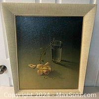 Front view of signed print "Weeping Rose" by Vladimir Tretchikoff framed in tapered wood frame. Print depicts still life scene with yellow rose, glass of water, playing card on dark background.