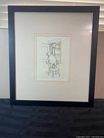 Framed signed sketch print of Winnie The Pooh reaching on a stool for a honey pot on a shelf.