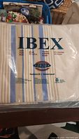 Ibex branded sheet set in packaging with blue, tan, and cream stripes. King size.