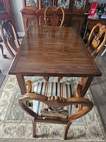 Overhead view of rectangular table top and surrounding chairs