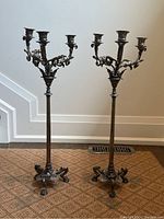 Pair of full-height candelabra displayed side by side