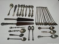 Overview of full cutlery assortment arranged on white background