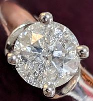 Close-up top view of round brilliant diamond showing four-prong setting