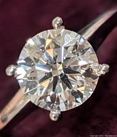 Front view showing round brilliant diamond and six-prong setting on white gold band