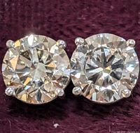 Close-up front view of round brilliant cut diamonds in four-prong settings