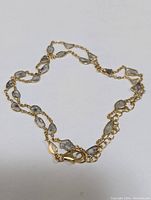 Full view of the necklace showing the natural salt and pepper diamonds set in gold-toned stainless steel chain.