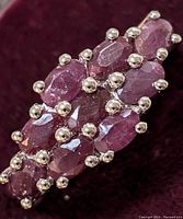 Close-up top view of ruby cluster on ring