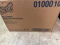 Box of Scott paper towels labeled 'Roll Towels - White', 12 rolls per box, 1000 ft each