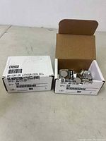 Box showing a quantity of CR2032 lithium coin cell batteries with labels and packaging visible.