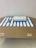 Top-down photo showing 30 boxes of DuraPlus facial tissues arranged inside a large cardboard box, all showing uniform packaging design.