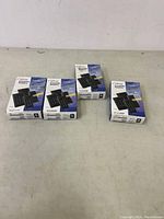 Photo showing four boxes of ioProx P225XSF proximity readers on a table, each box depicting a black keypad device on front.