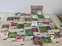 Large spread of multiple seed packets on surface showing variety in the lot.