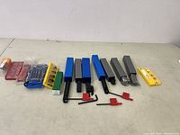 All machining bits and inserts laid out on table showing full set and packaging.