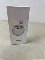 Front of sealed PLug wireless earbuds box showing earbuds and charging case image.