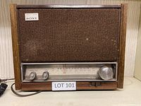 Front view of the vintage Sony AM FM radio showing wood casing and speaker grille.